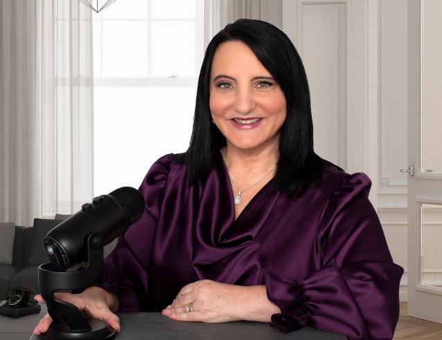 Dr. Roseann Capanna-Hodge at her podcast microphone